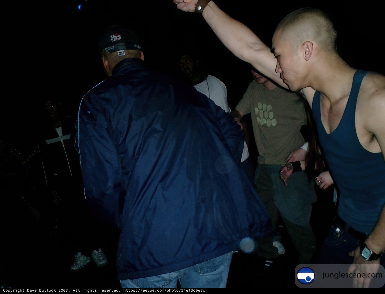 Man Dancing with Another at Night Club