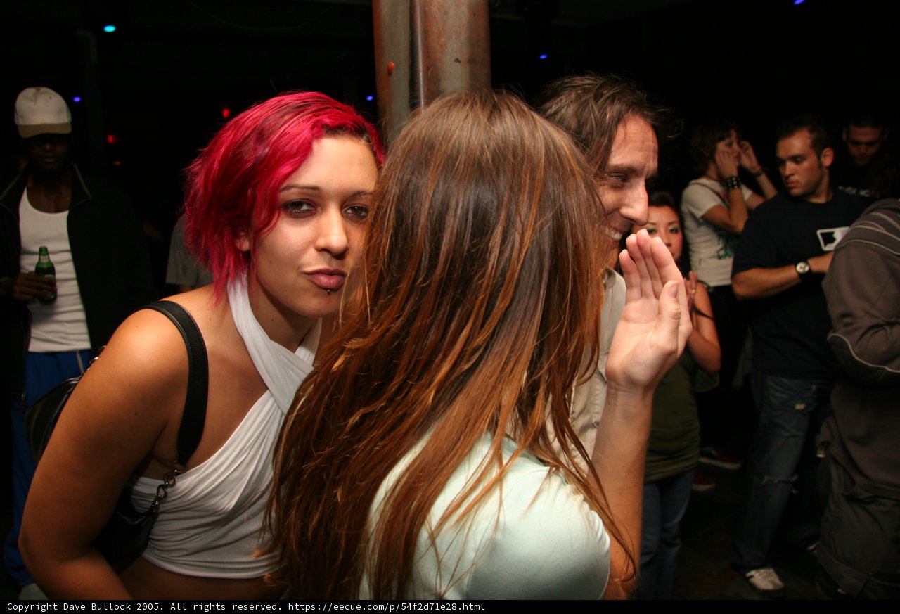 Red-haired Woman with Handbag in Night Club