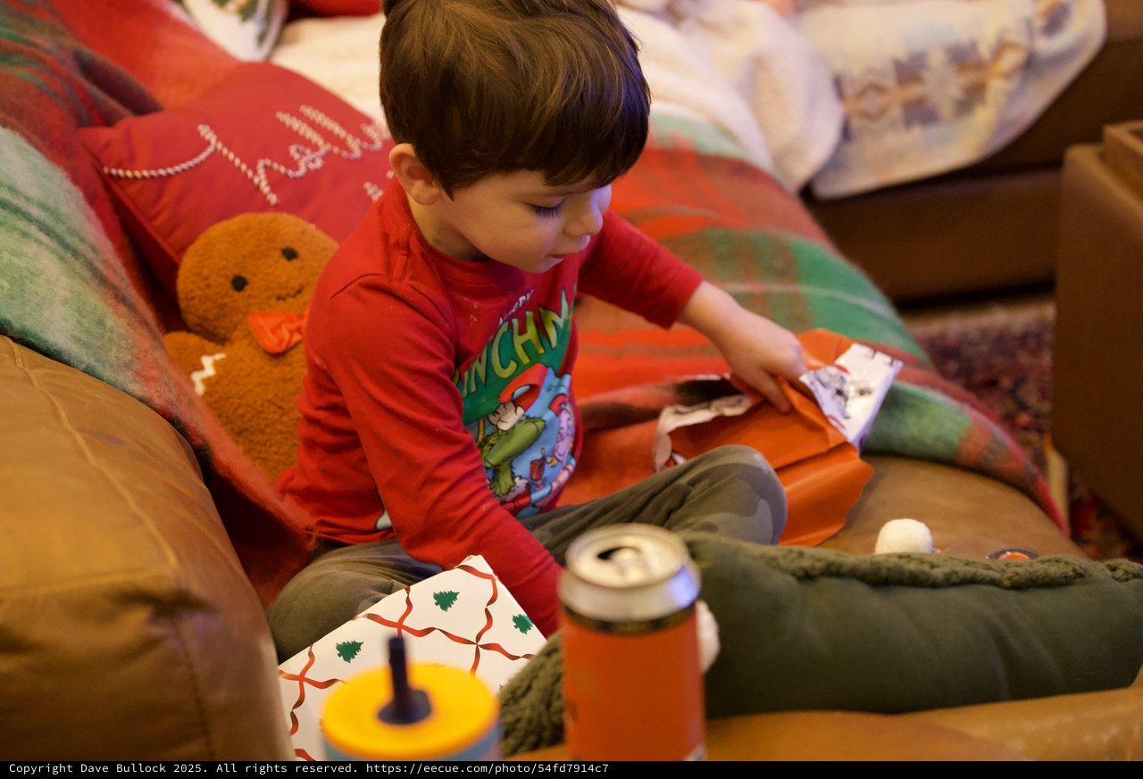 Child Opening Christmas Presents on Cozy Morning