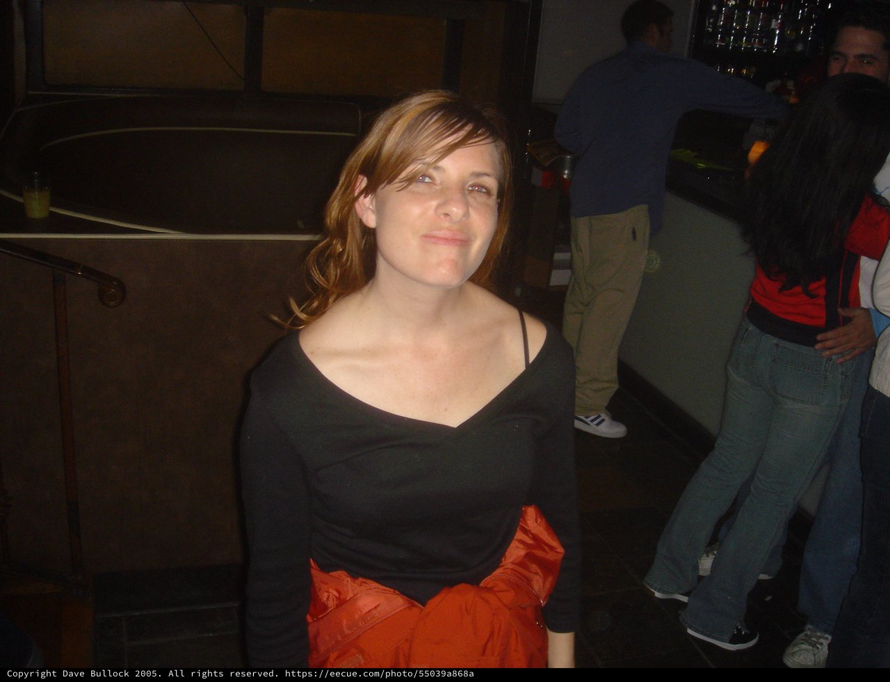 Woman Smiling at a Nightclub Social Gathering