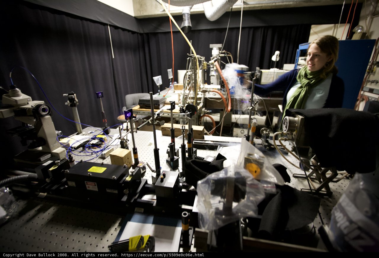 Woman operating high-tech machinery in a cutting-edge lab