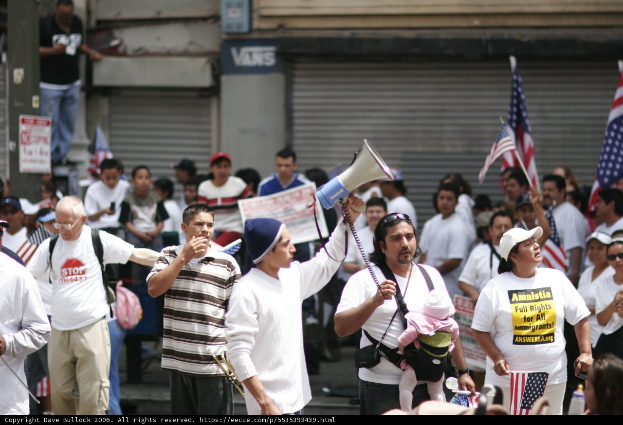 City Parade of People Holding Signs and Flags