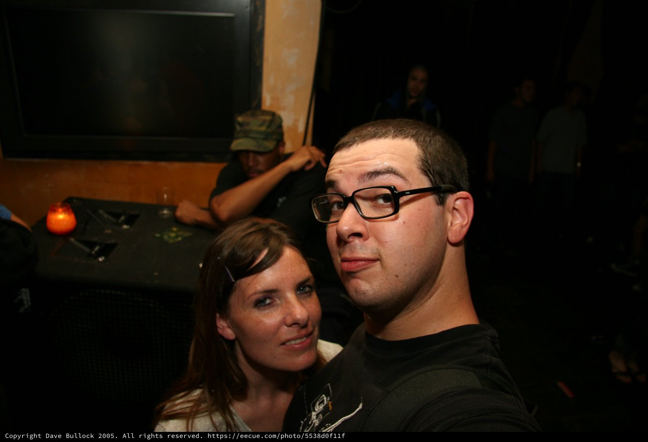 Two Friends Pose at a Dimly Lit Nightclub