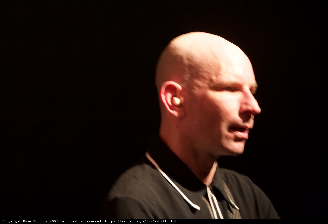 Bald Man Belting it Out on Stage