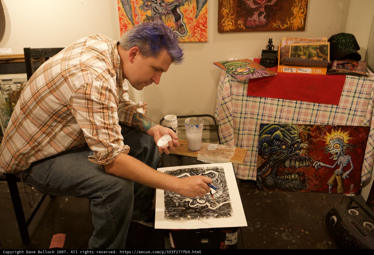 Purple-haired man creating a masterpiece