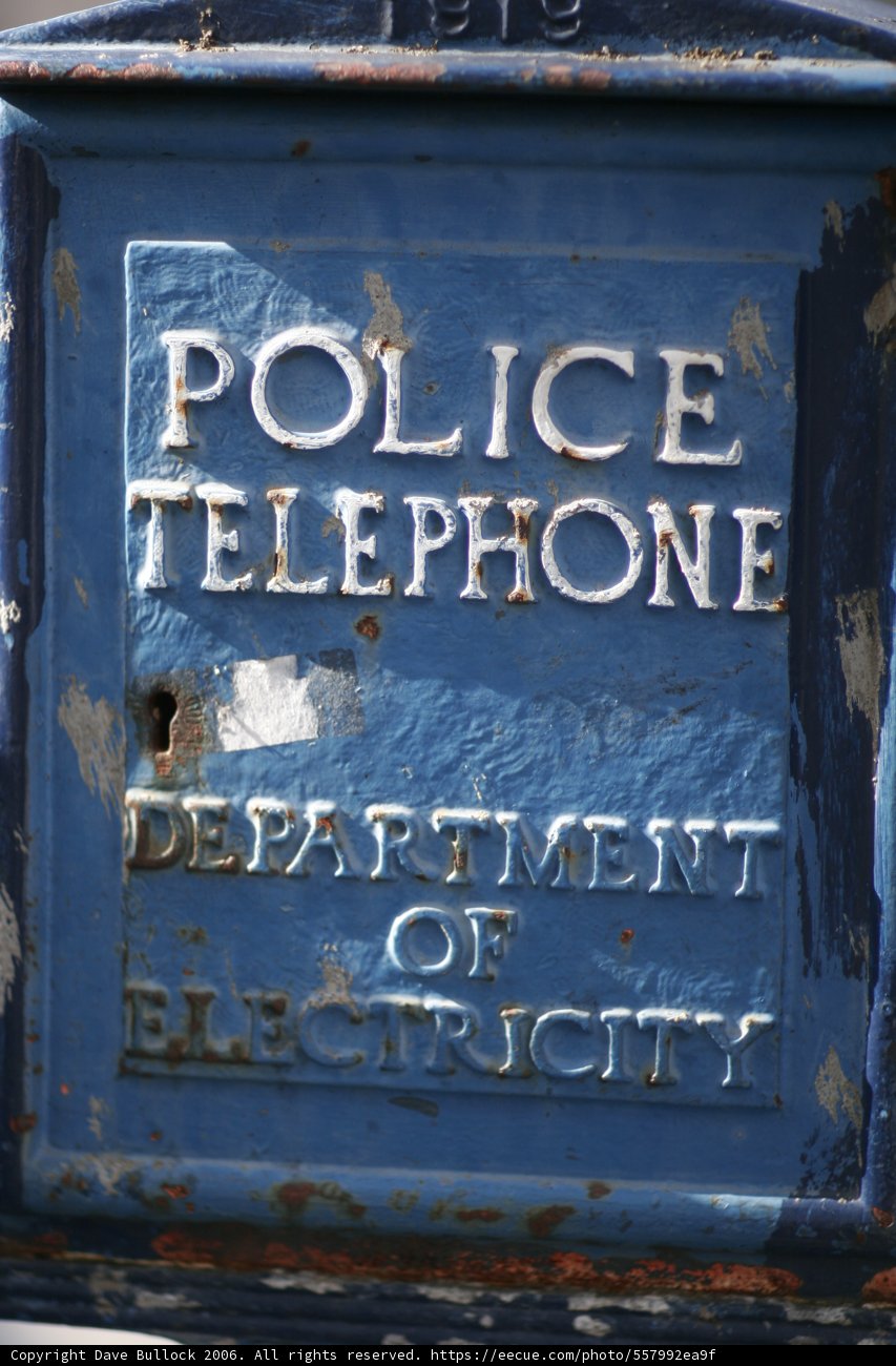 Police Telephone Department Box Caption: A vintage blue box labeled "Police Telephone Department" stands on a San Francisco street corner, complete with a plaque and mailbox.