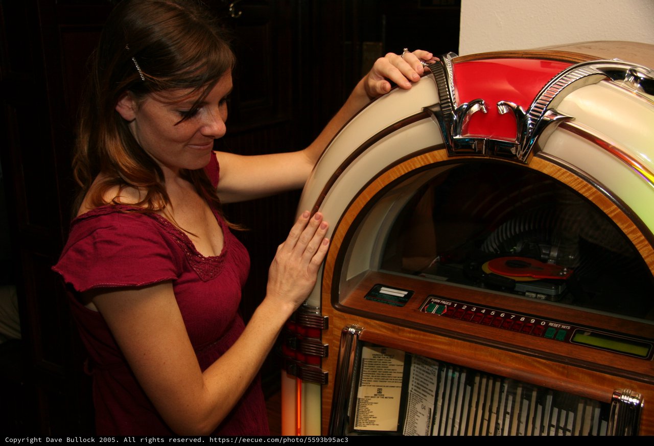 Nostalgic Woman Exploring Vintage Wurlitzer Jukebox