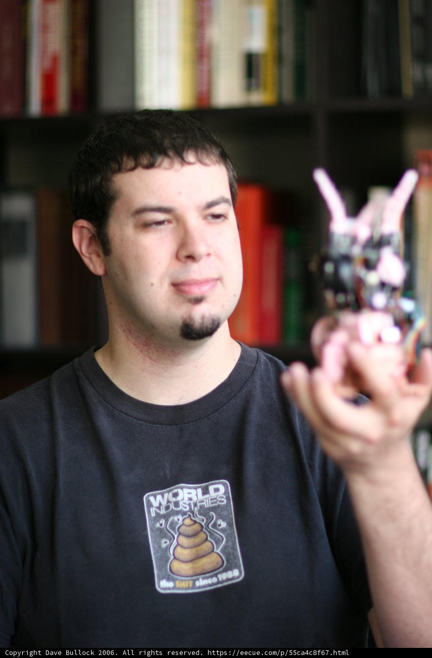 Man Relaxing with Toy on Bookshelf