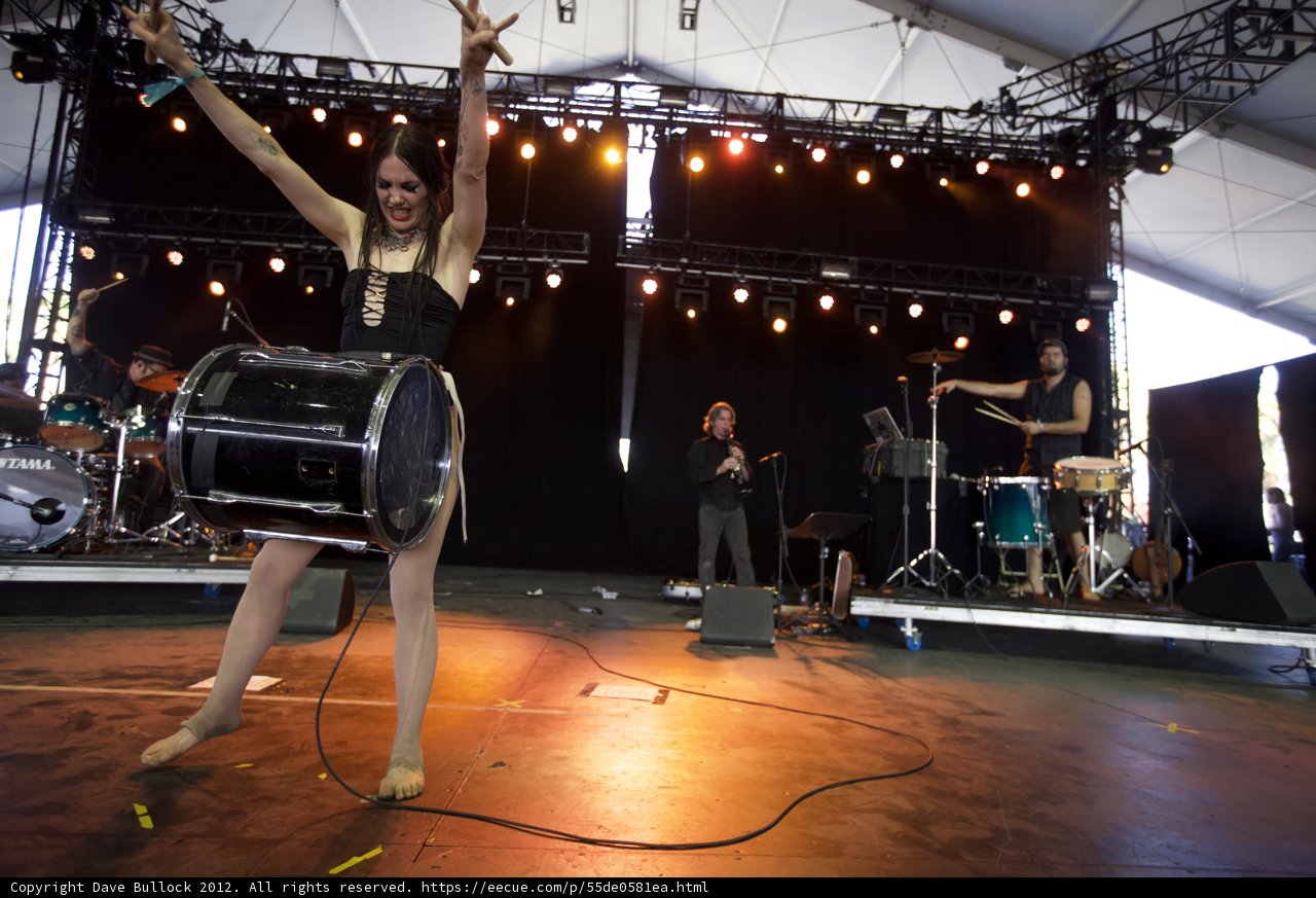 Stage Spotlight on Woman with Arms Up