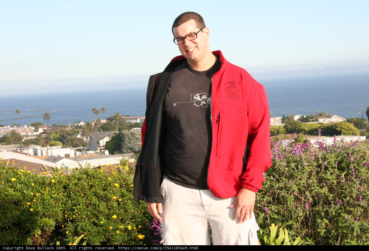 Man in Red Jacket Enjoys Ocean View