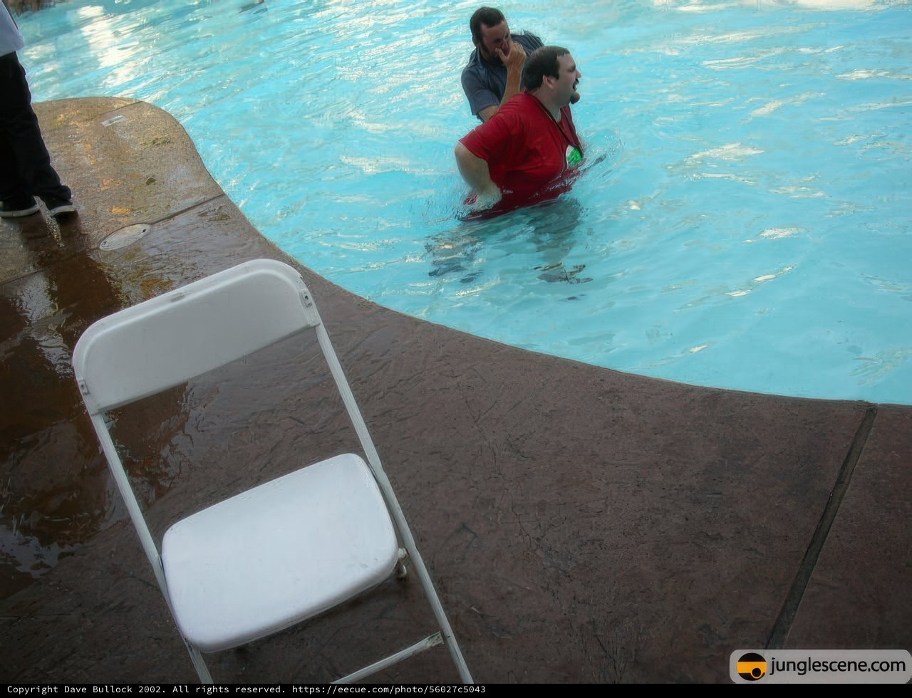 Man Relaxing in Pool With Chair