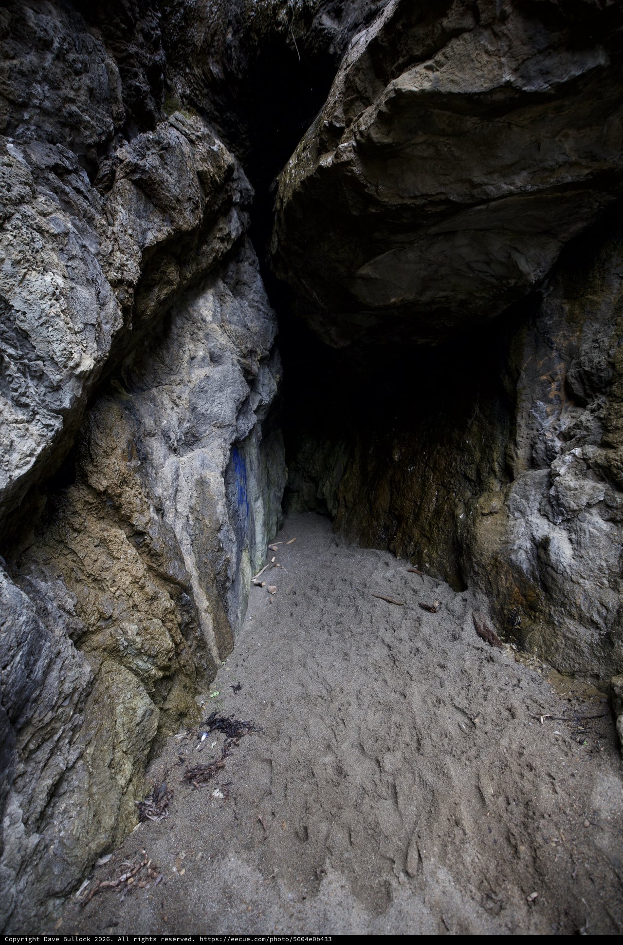 Dark Cave Entrance Framed by Ancient Rocky Walls