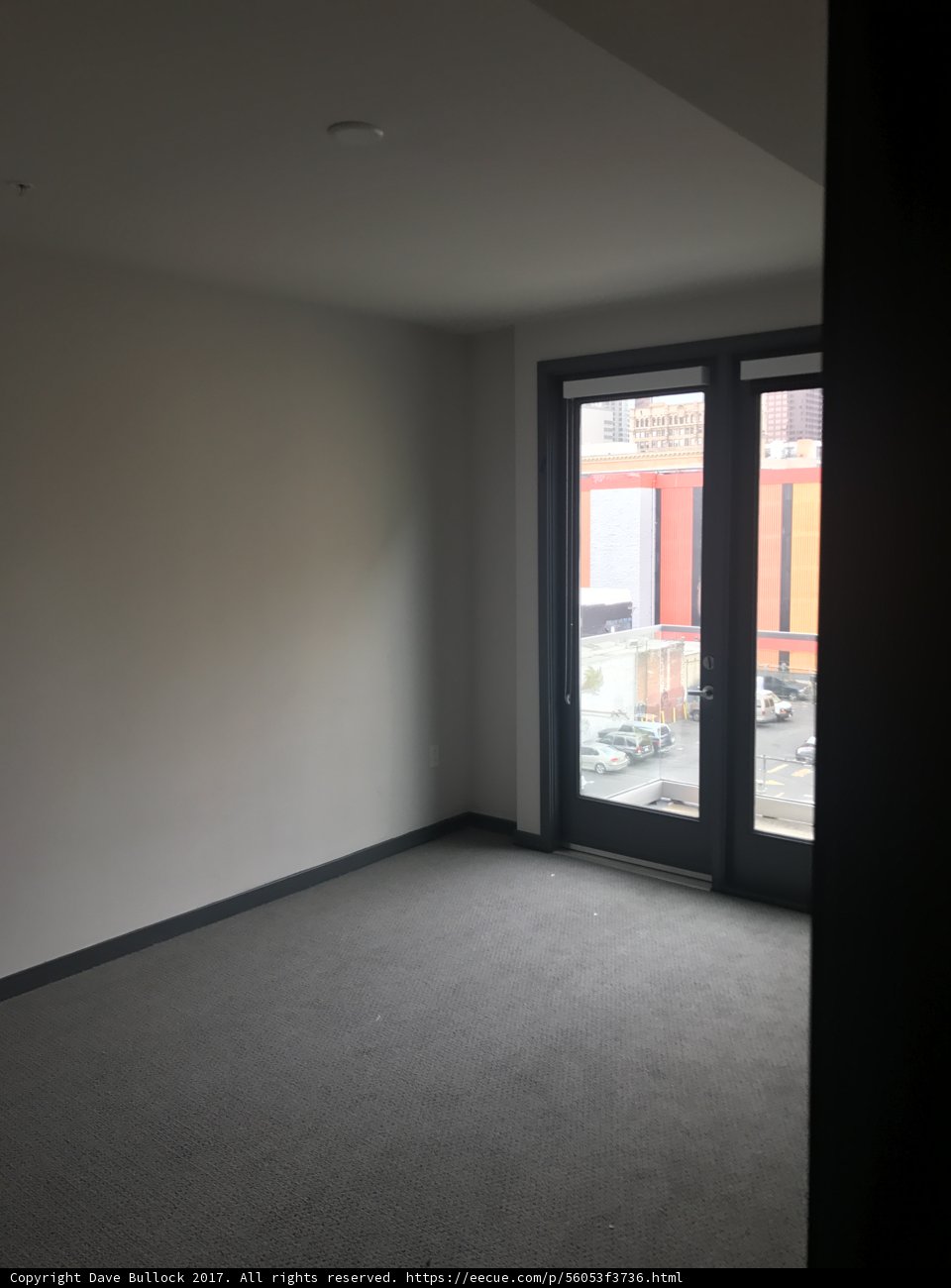 Empty Room with Large Window and Door