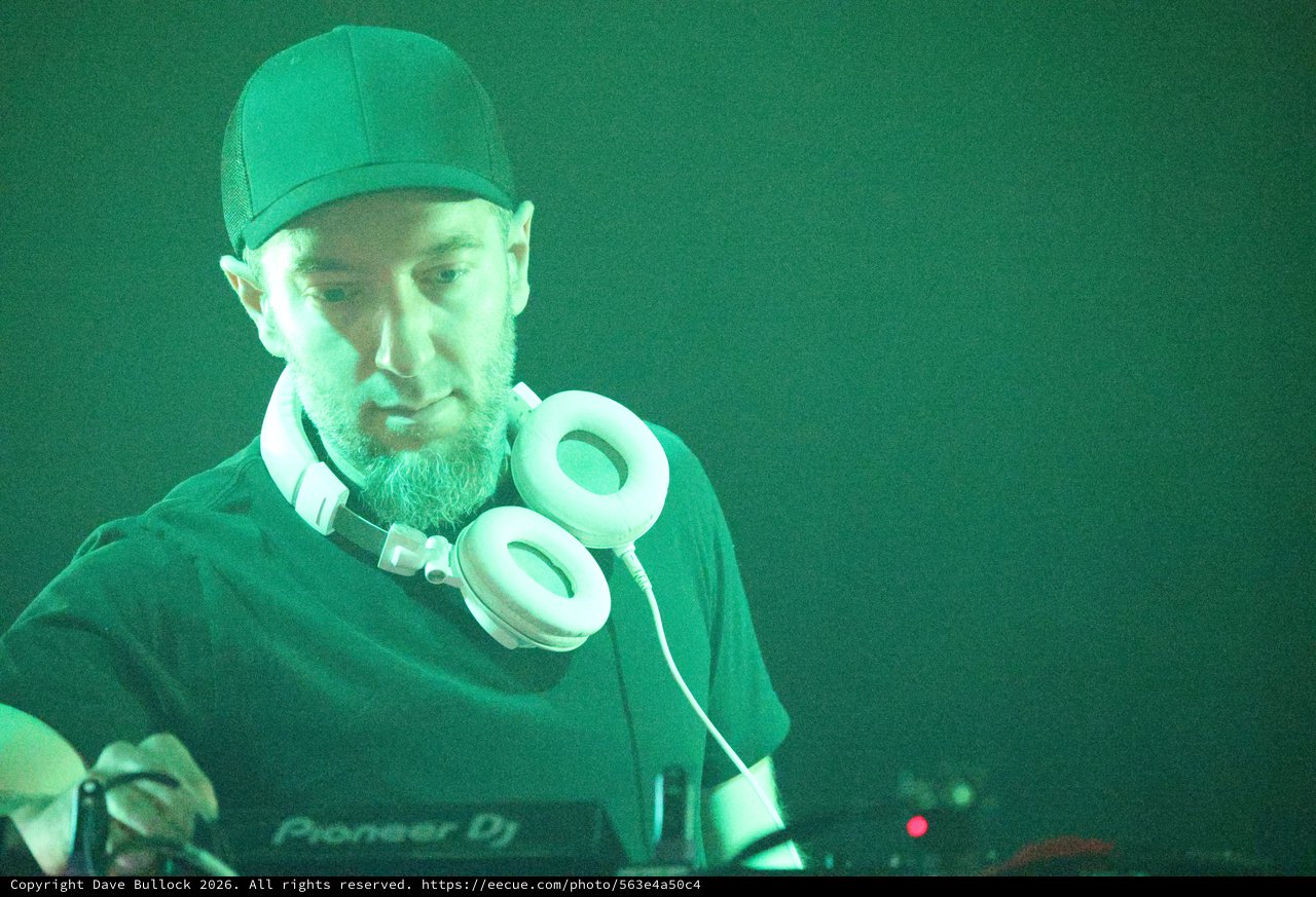 DJ Focused at the Decks Under Green Lights
