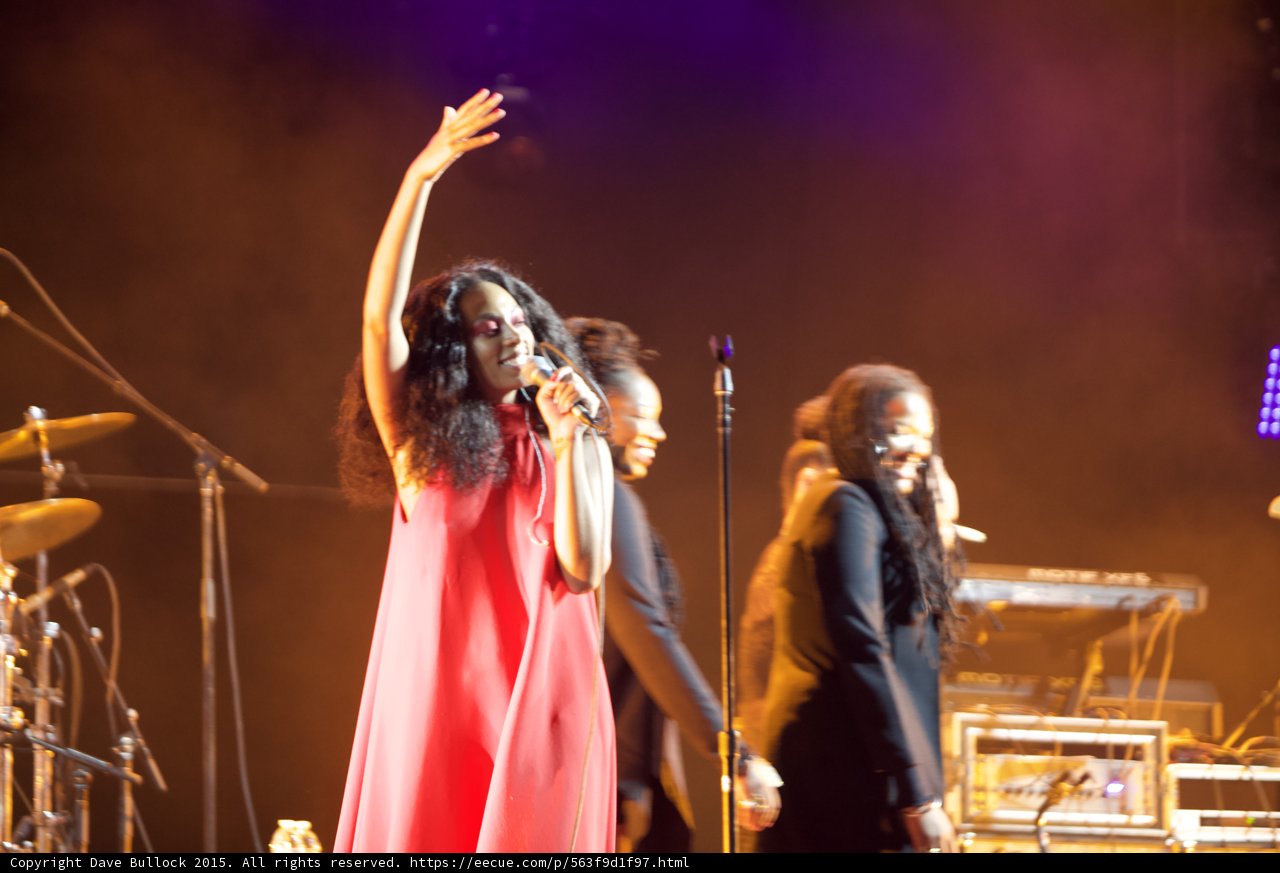Solange Waving Red Dress Arm Raised Backing Vocalists Dreadlocks Smiling Orange Haze