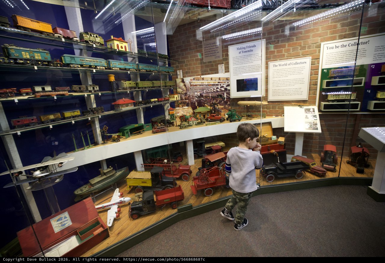 Young Boy Exploring Vintage Toy Museum Collection