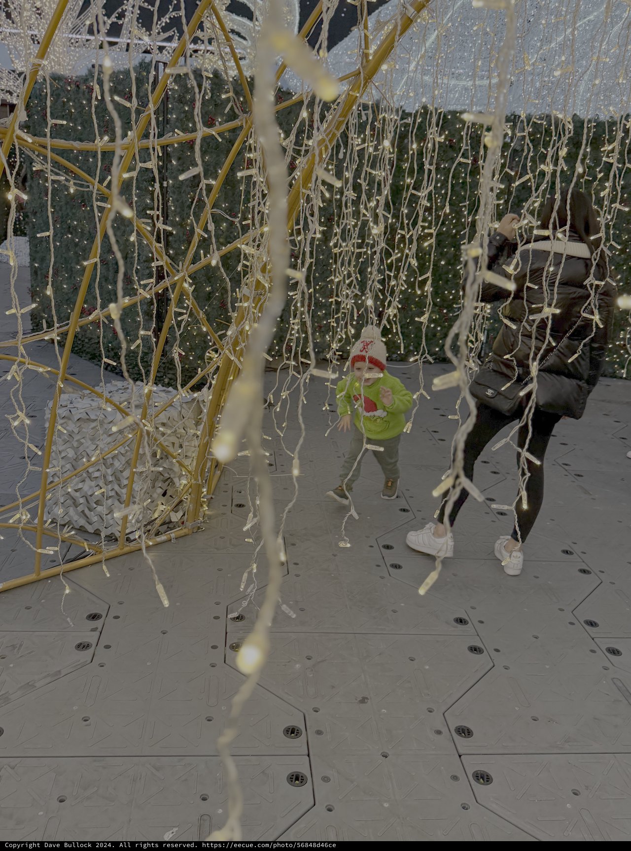 Children Playing in Festive Streamers Installation