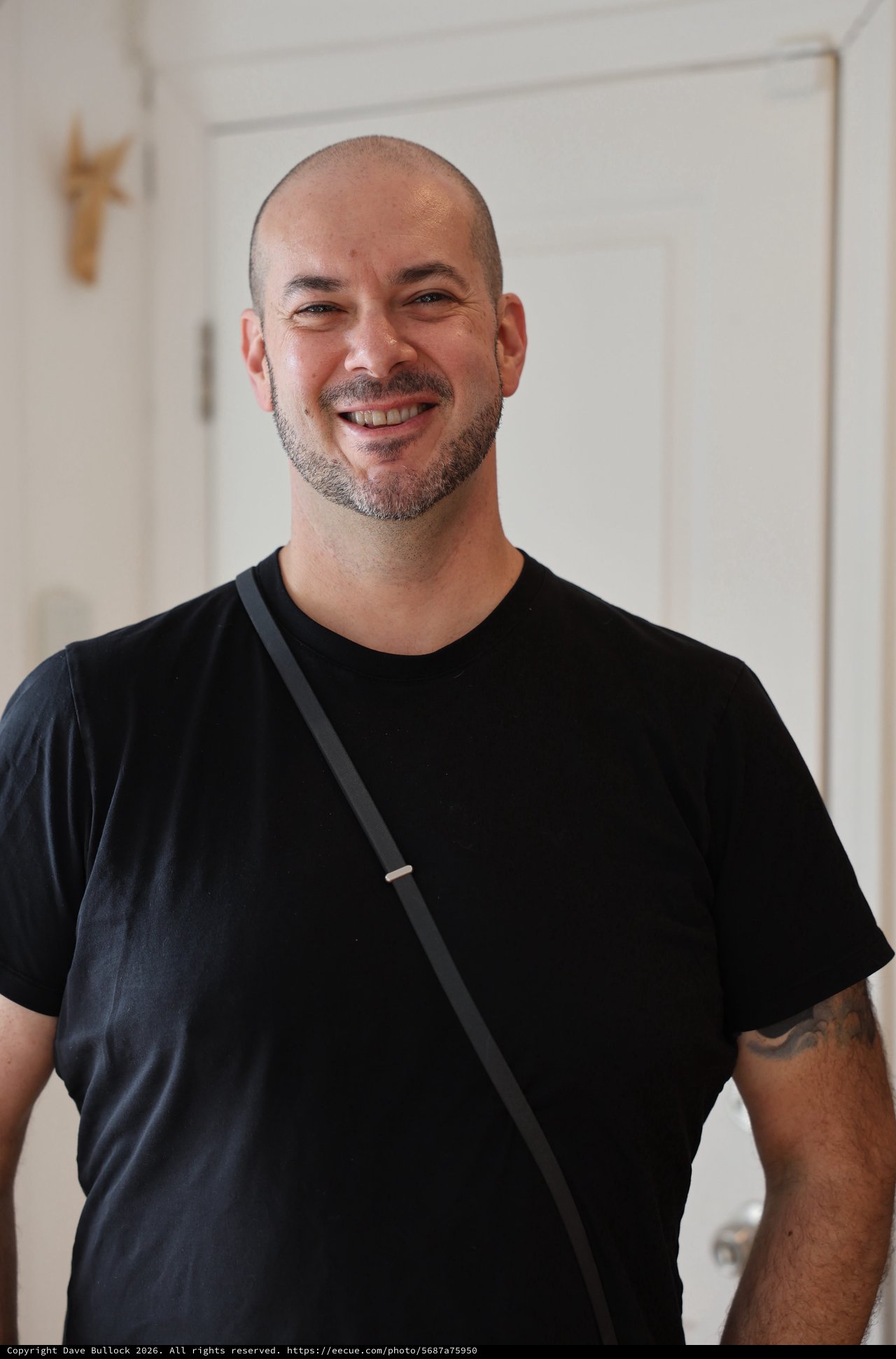 Warm Portrait of Smiling Man in Black T-Shirt