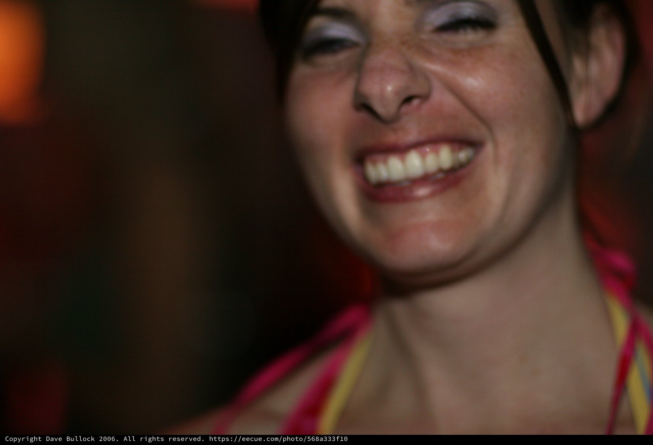 Joyful Woman Laughing at a Nighttime Event