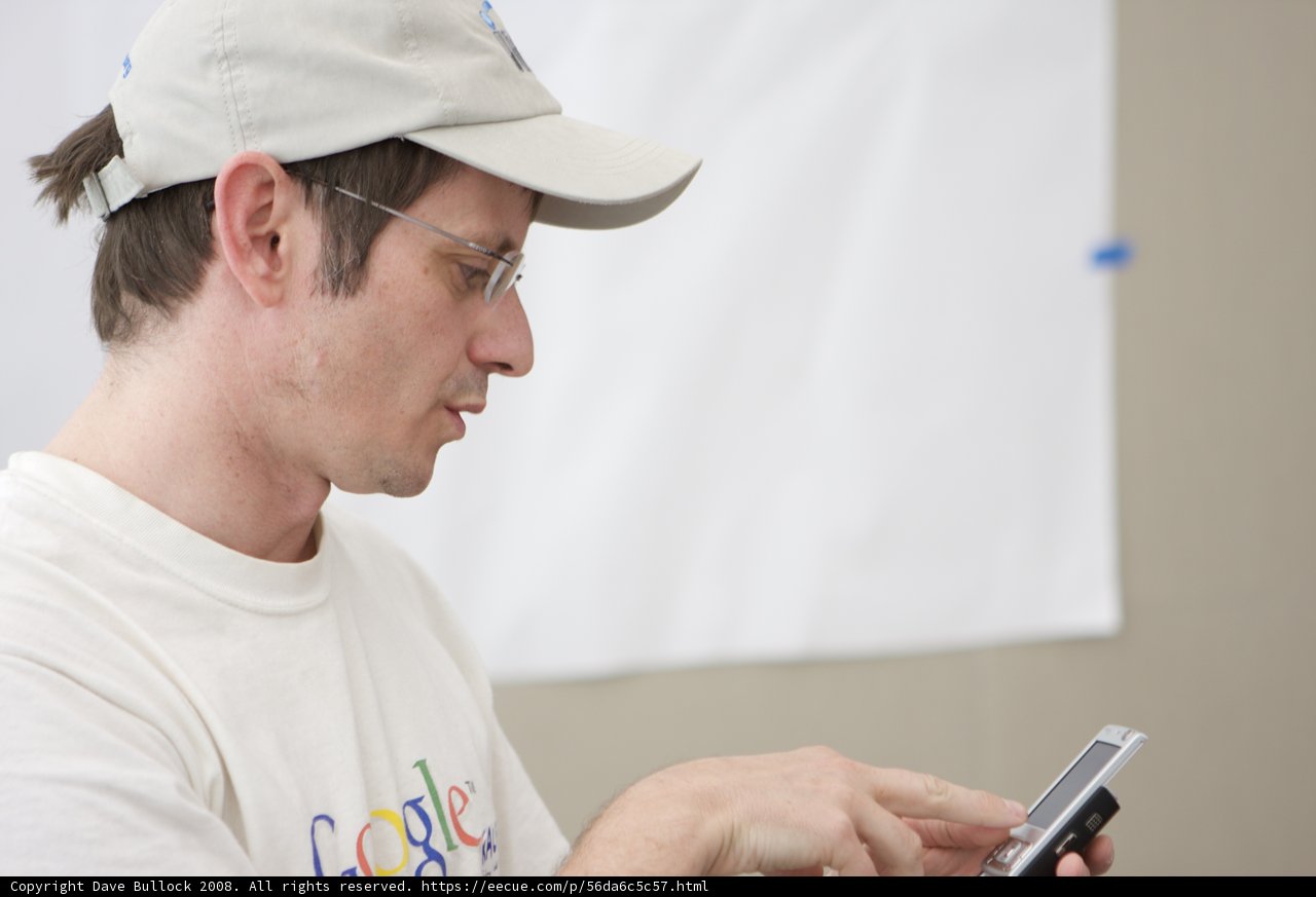 Tech-Savvy Man in Baseball Cap