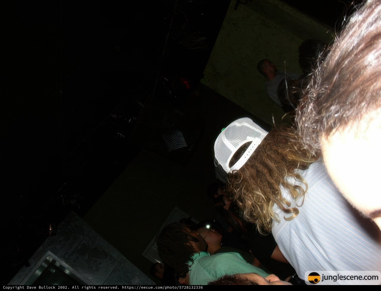 White-Hatted Man Takes Center Stage at Night Club