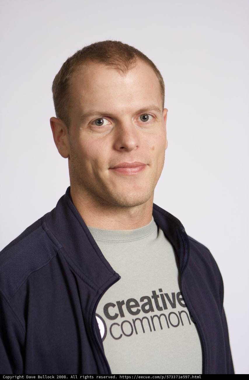 Timothy Ferriss in a Blue Jacket and White Shirt