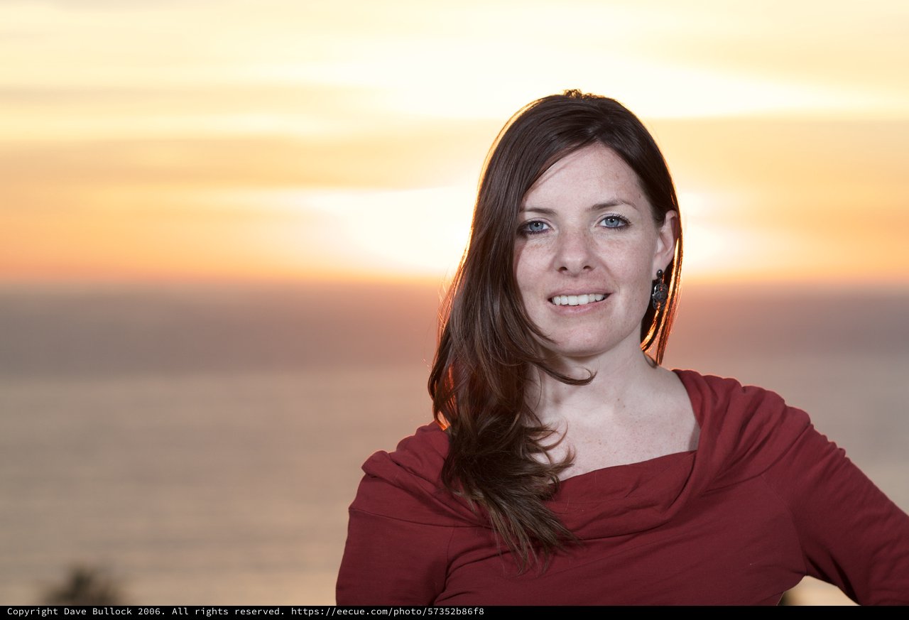 Woman Smiling at Golden Hour Ocean Sunset