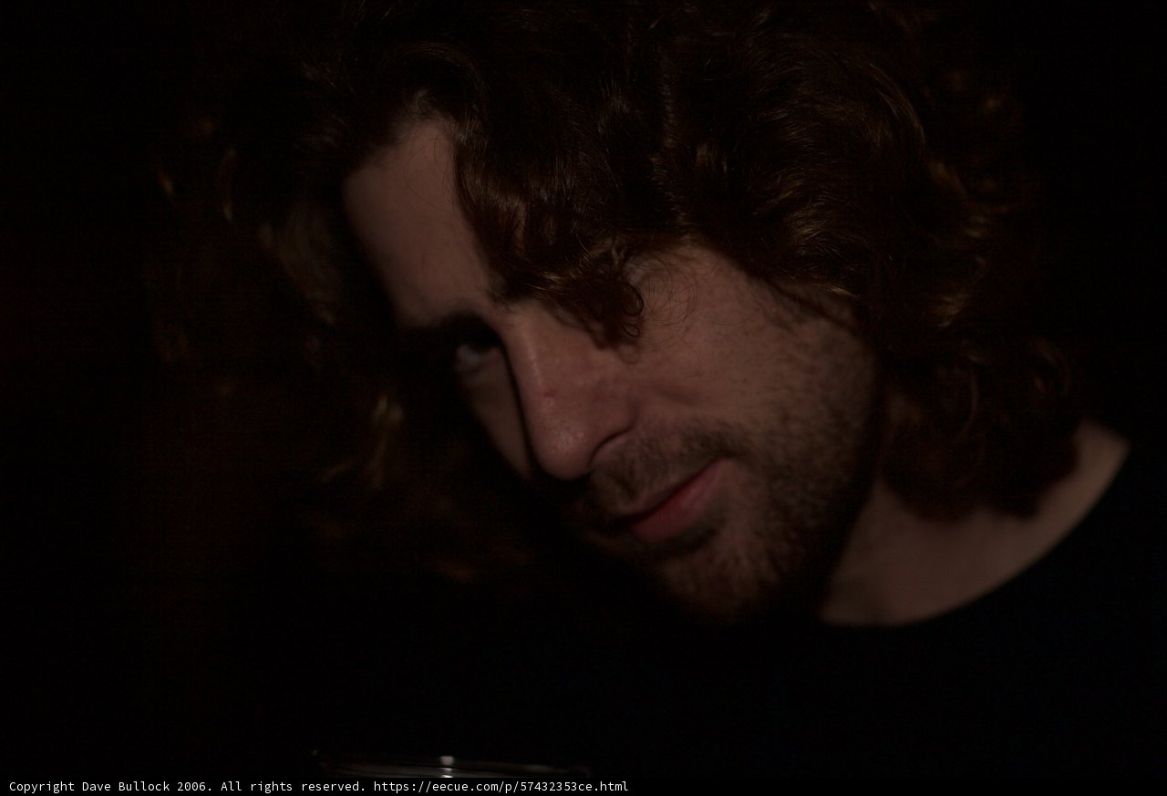 Curly-Haired Man in Black Shirt