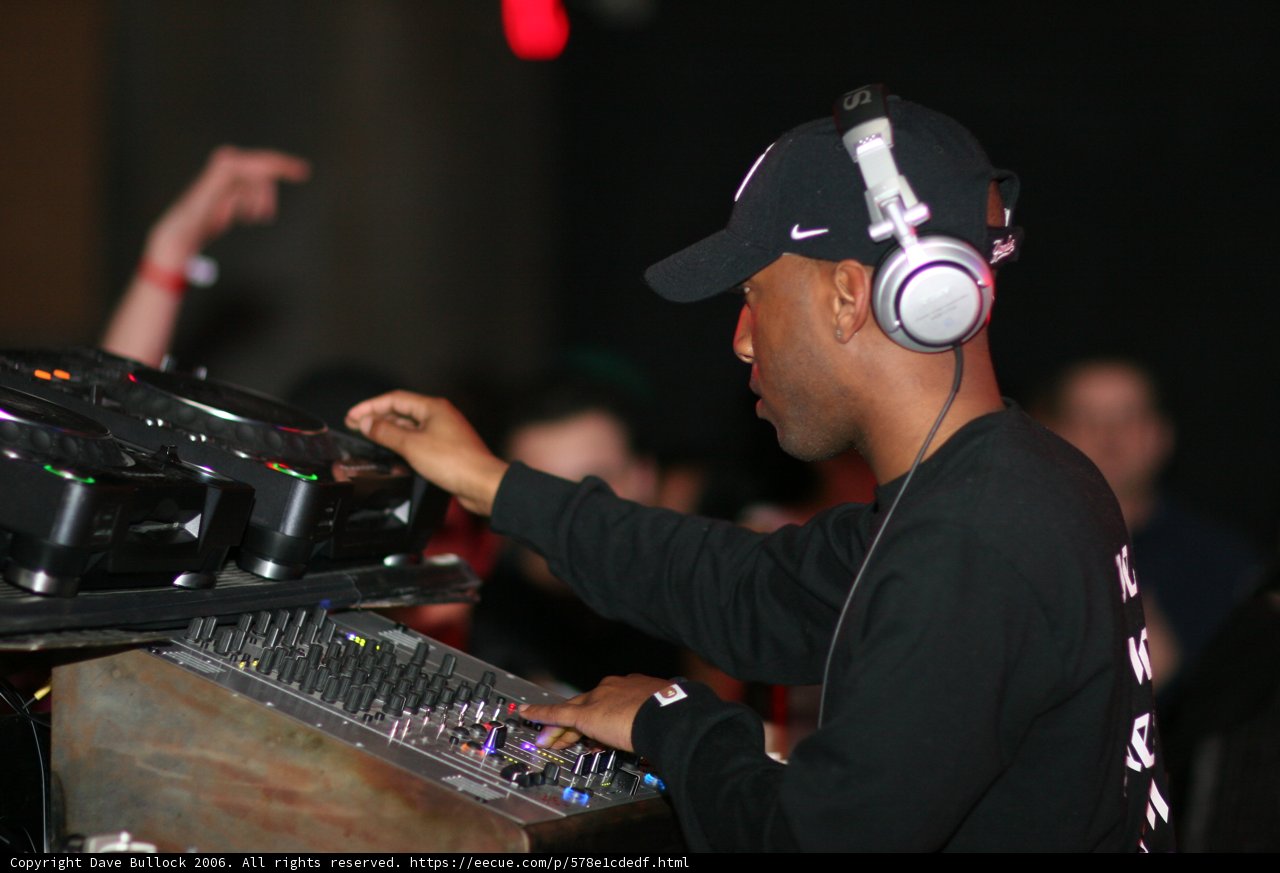 Black Shirted DJ Spinning on his Turntable