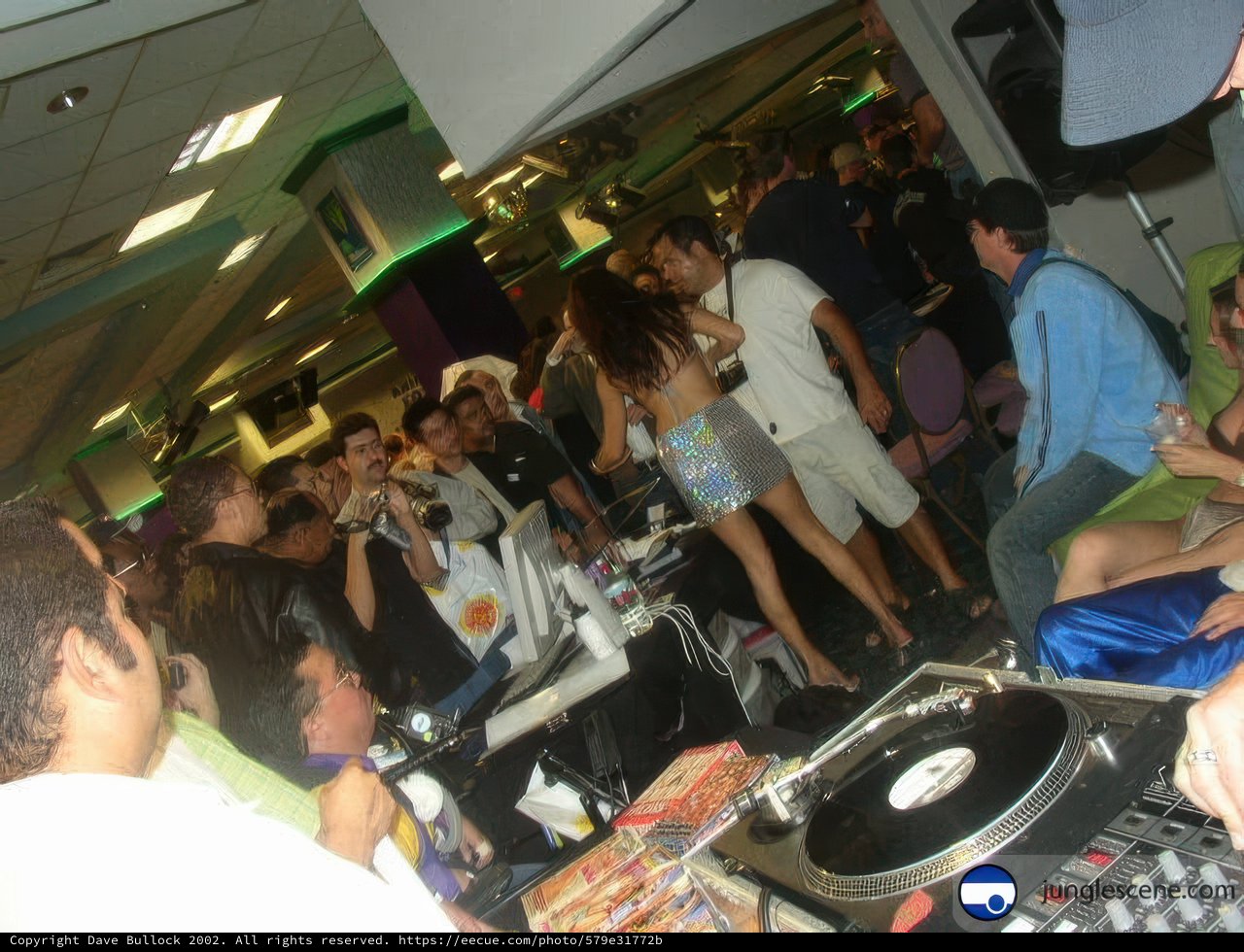 Nightclub Crowd Dancing to DJ's Mix