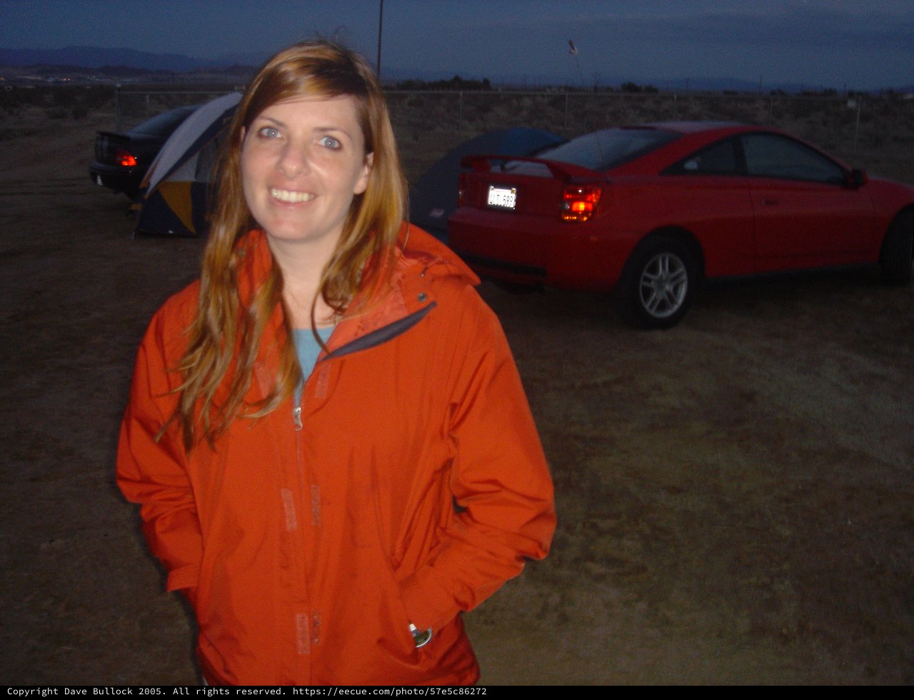 Woman Smiling at Desert Campsite at Dusk