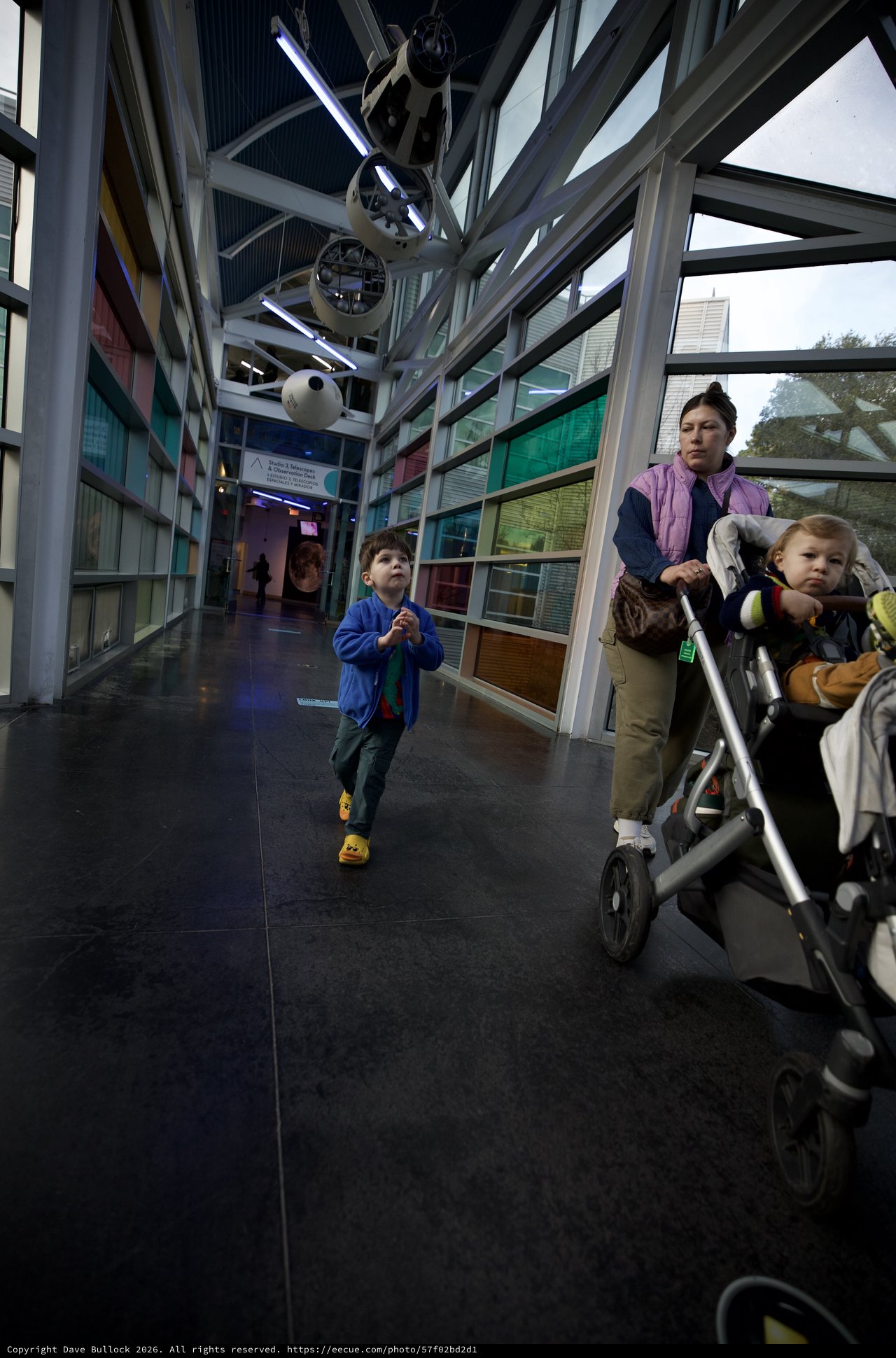 Family Explores Interactive Science Museum Corridor