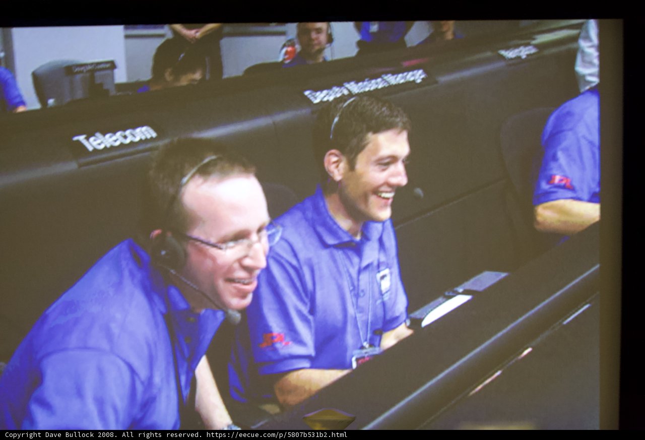 Blue-Shirted Men Smiling for the Camera