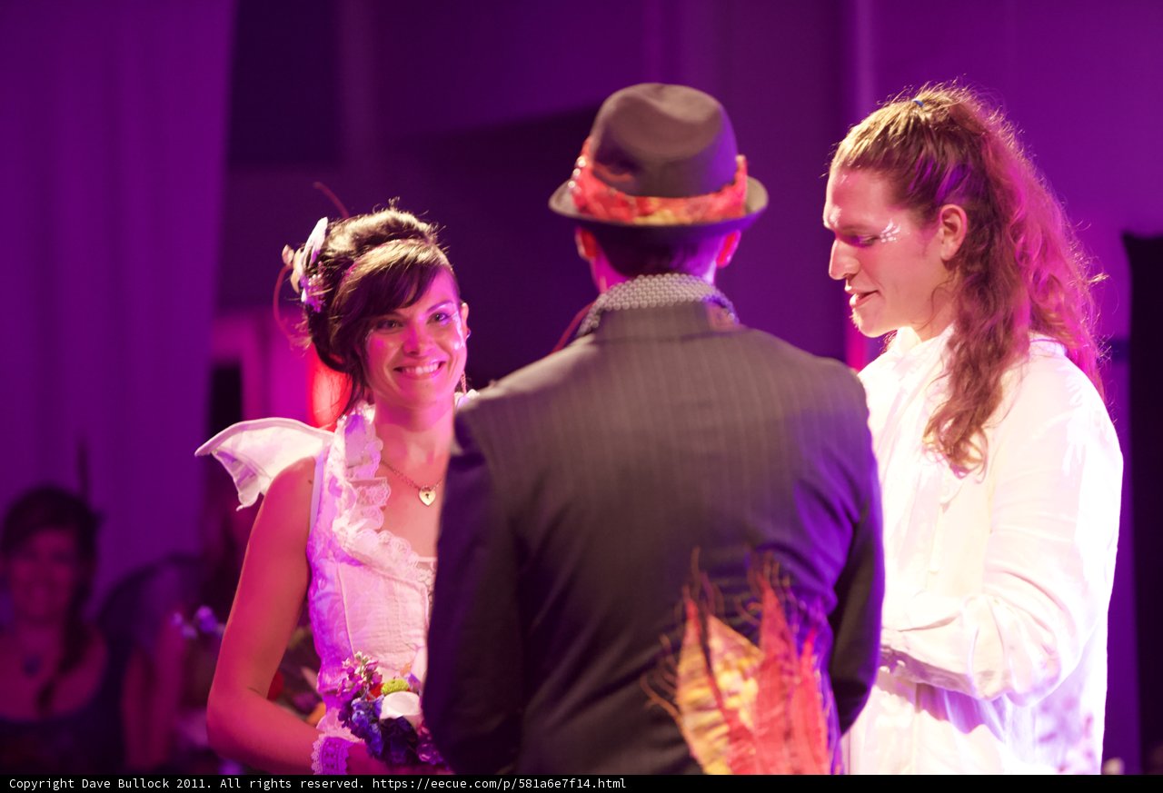 Smiling Bride and Groom in Purple Fedora Hats