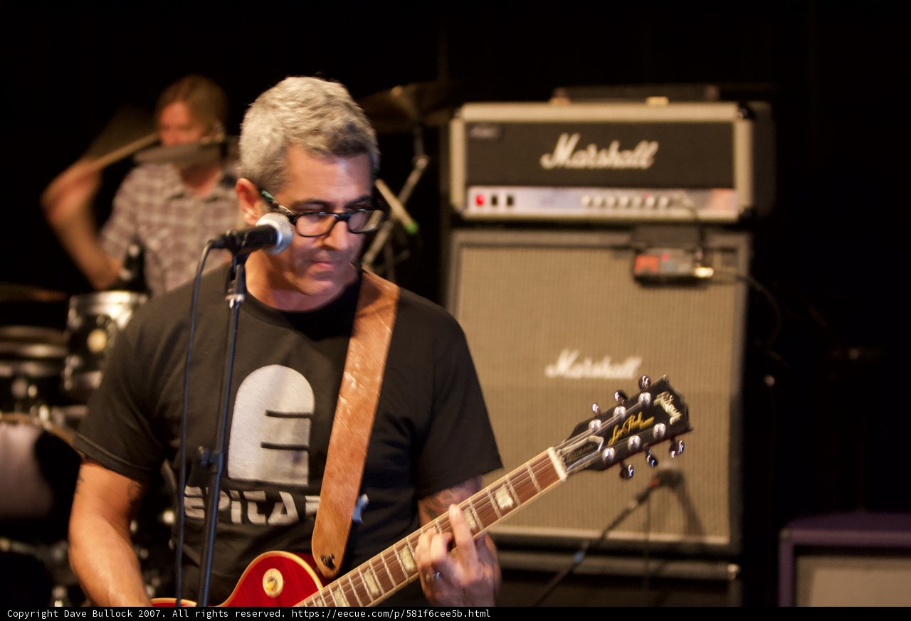 Brett Gurewitz rocks out on electric guitar at Glasshouse concert