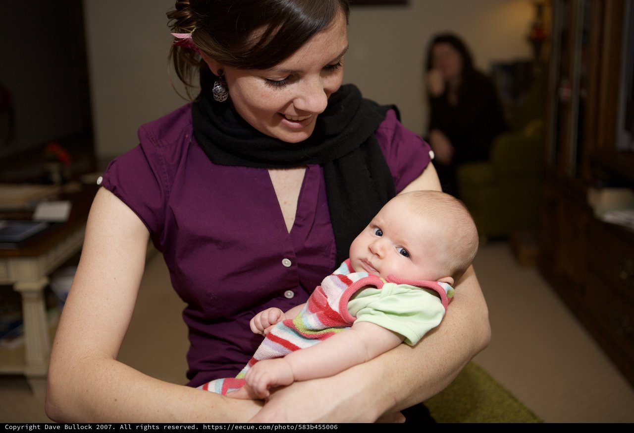 New Mother Lovingly Cradles Her Newborn Baby