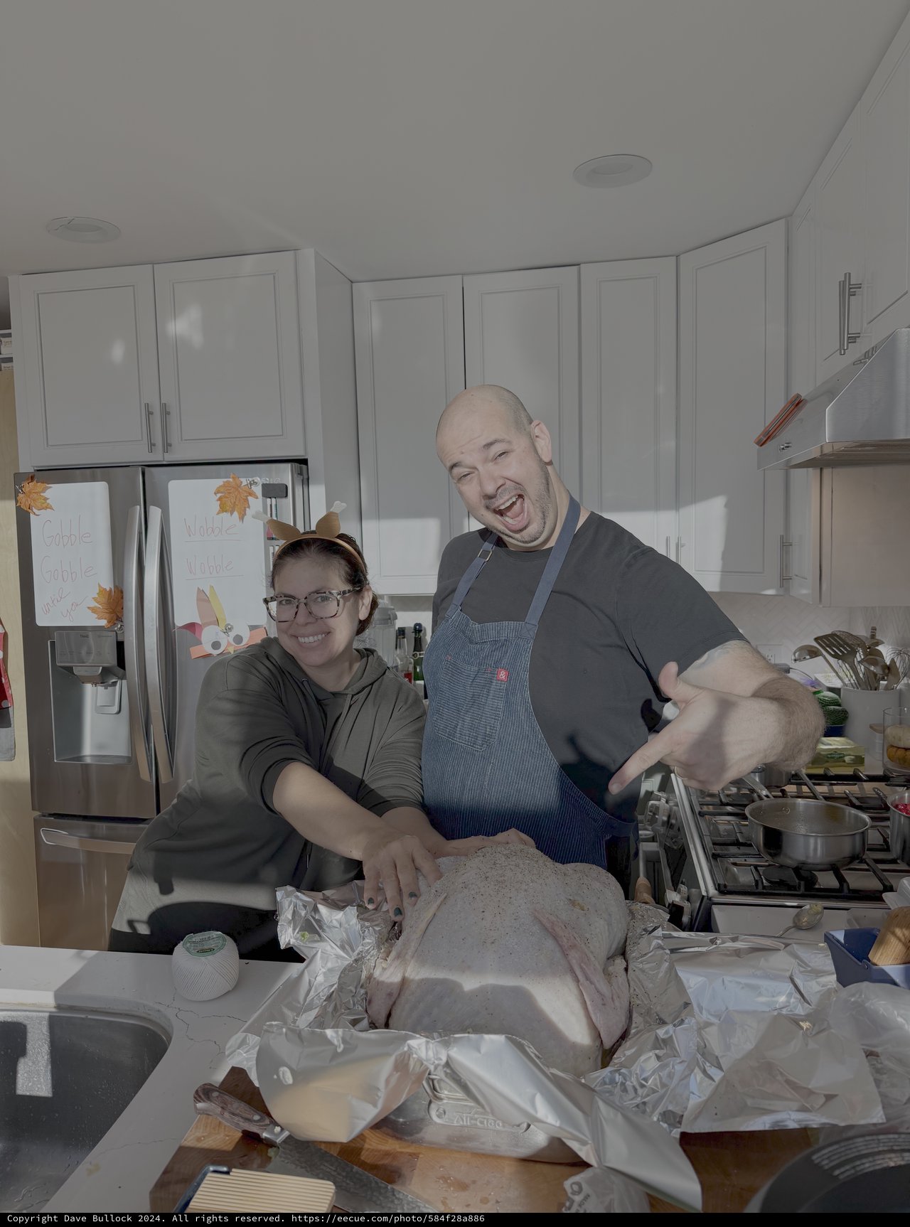 Happy Couple Preparing Thanksgiving Turkey Together