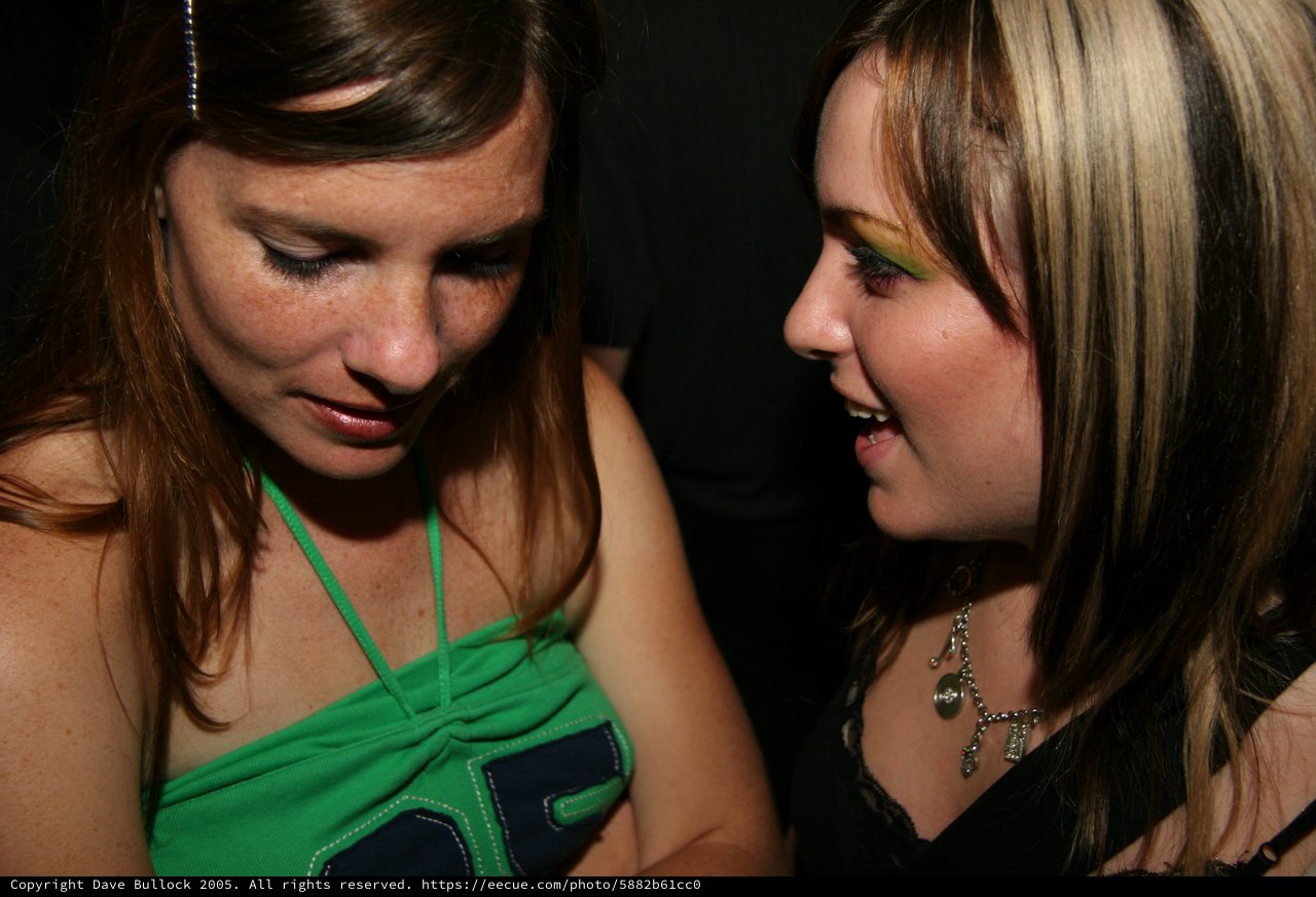 Two Young Women Sharing a Moment at Night Event