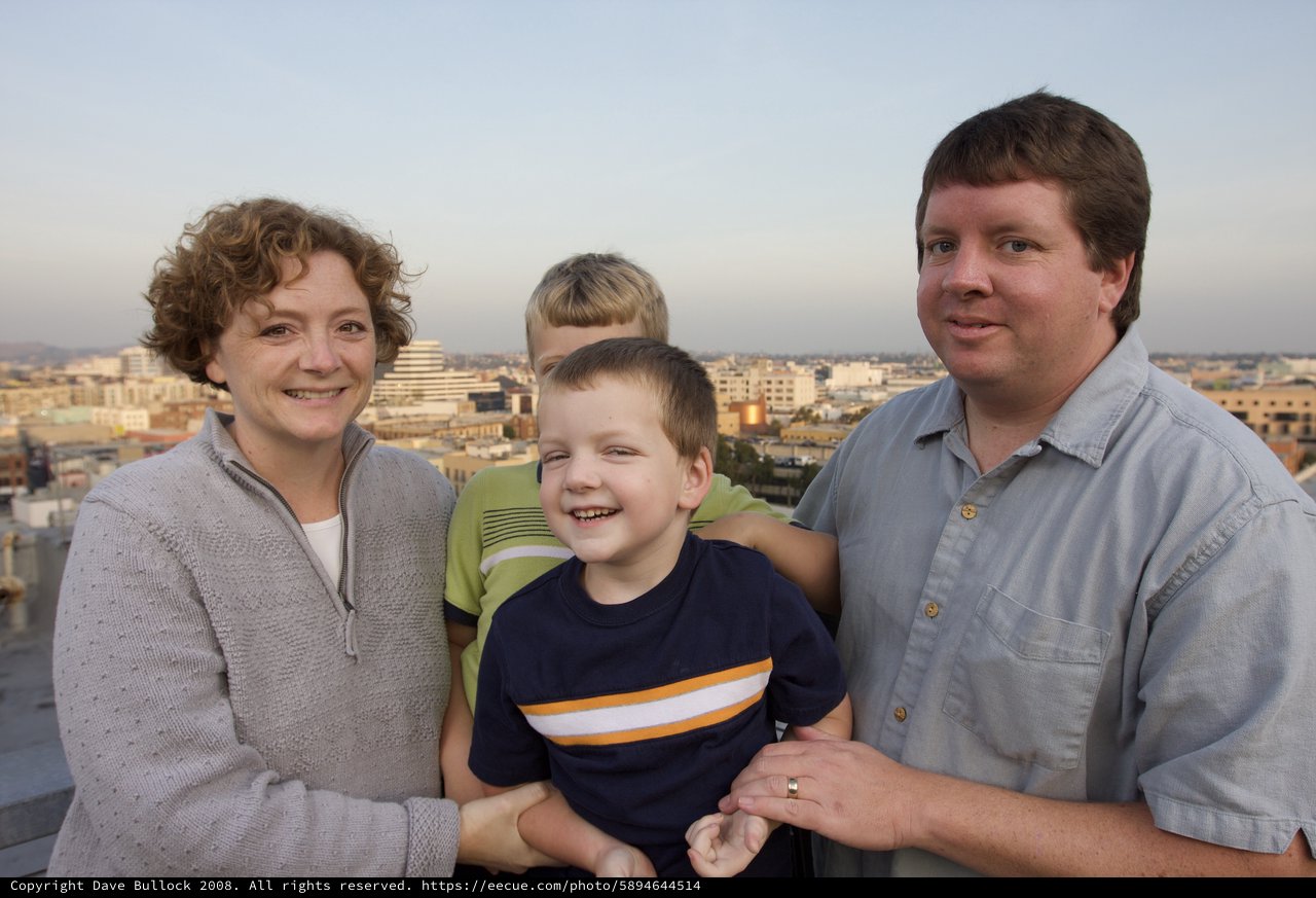 Family Portrait at Sunset Overlooking City Skyline
