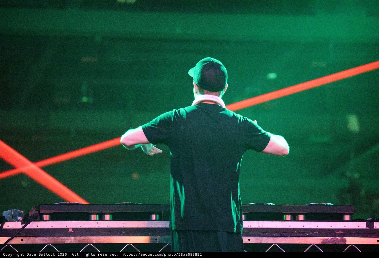 DJ Commands the Stage Under Laser Light Show