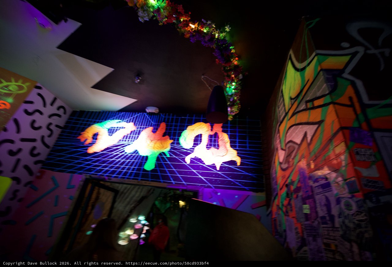 Vibrant Neon Vaporwave Art Installation in Dark Gallery Space