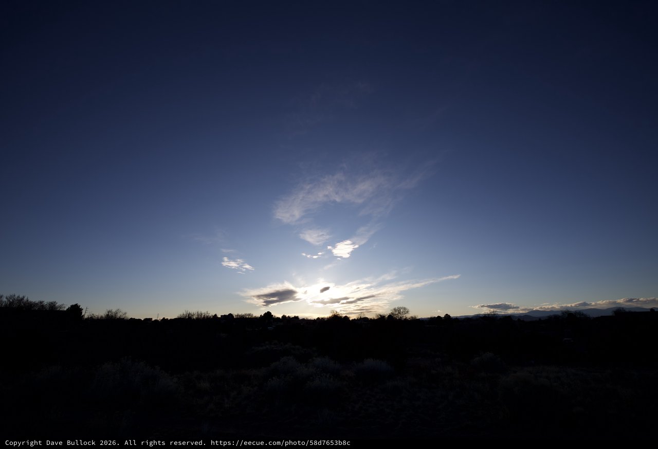 Twilight Sky Over Desert Landscape with Wispy Clouds