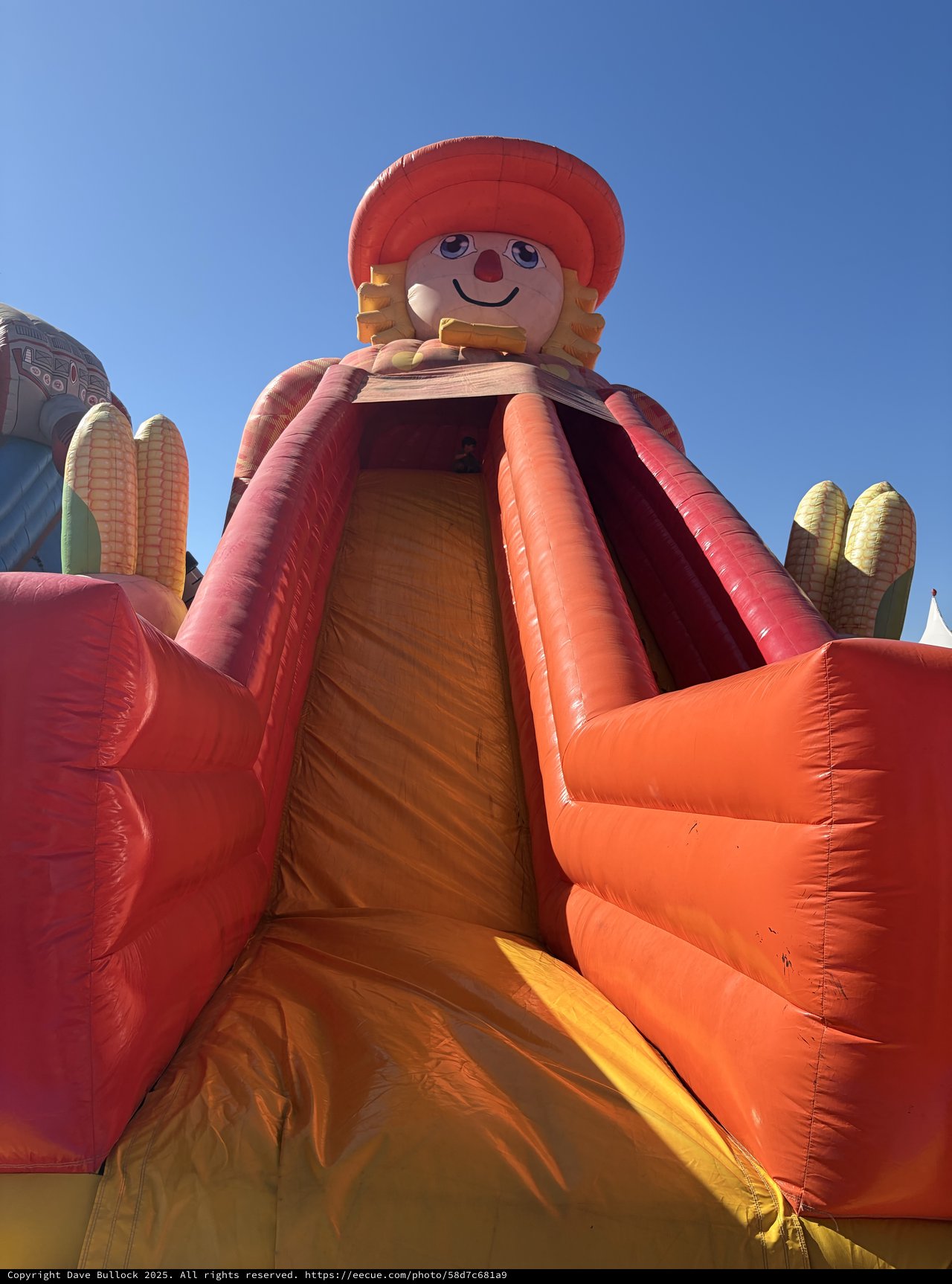 Giant Inflatable Farmer Character with Corn at Festival