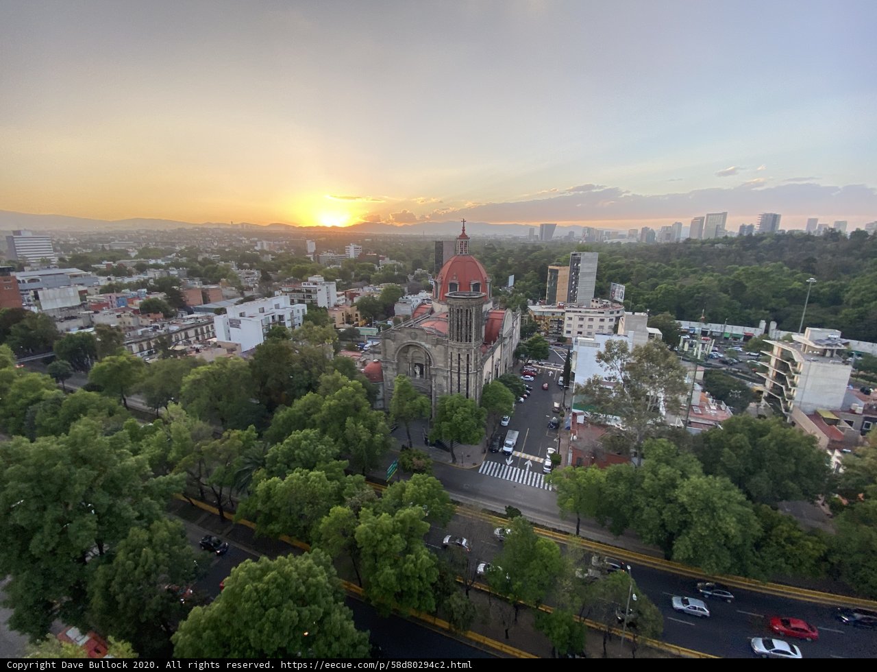 Cityscape at Sunset with Church in Background