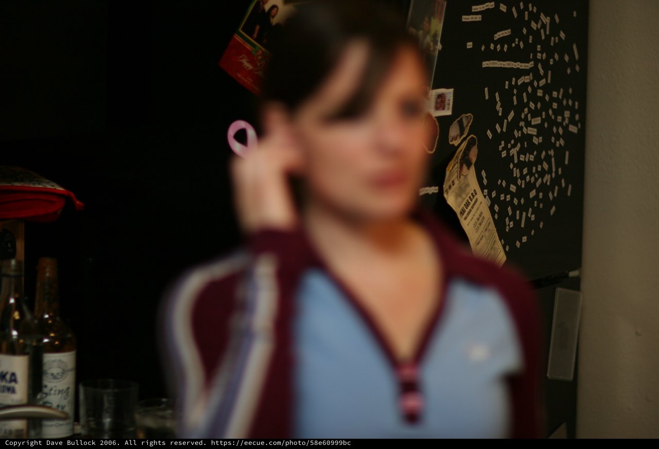 Blurred Portrait of Woman on Phone at Night