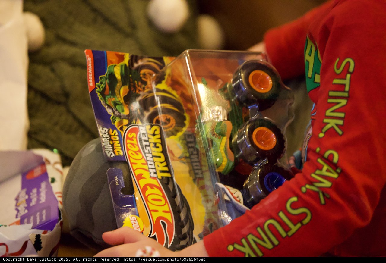 Child Opening Monster Trucks Toy on Christmas Eve