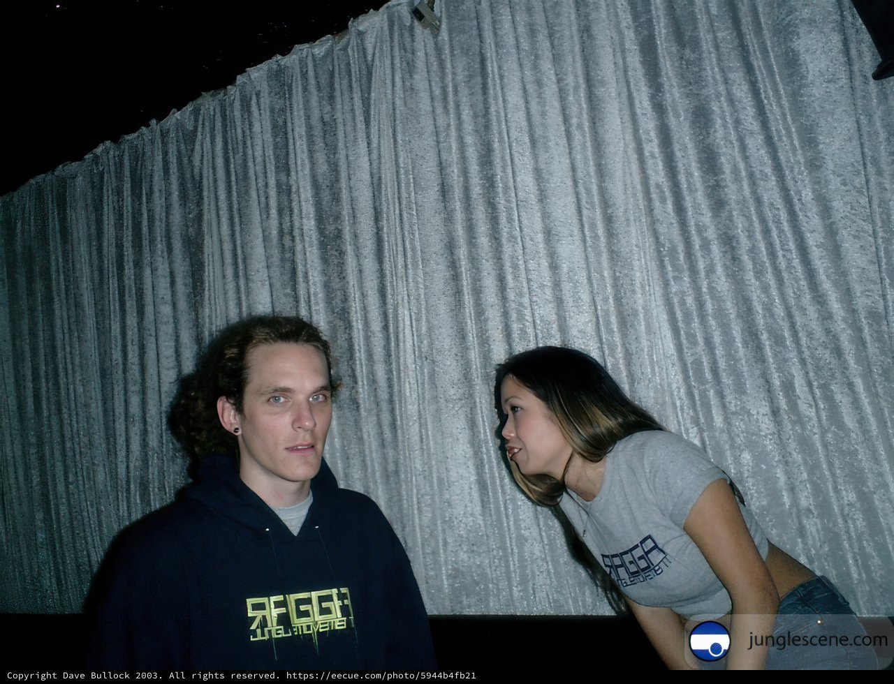 Couple Poses in Front of Curtain