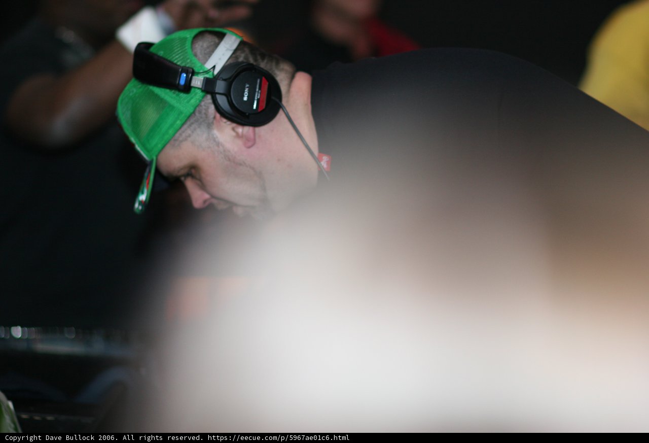 Man in Green Hat Grooving with Headphones