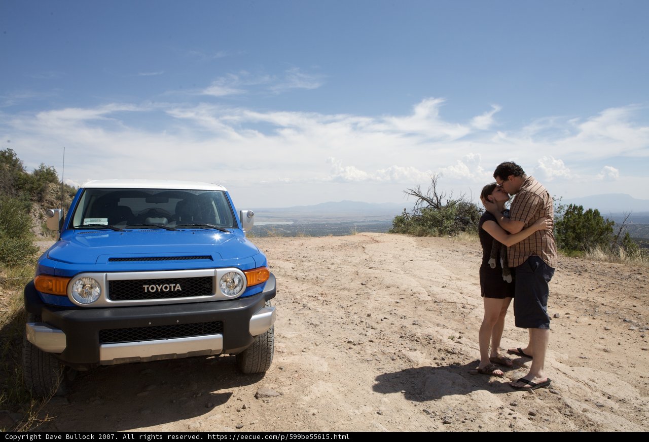 Hugging in Front of a Blue Truck