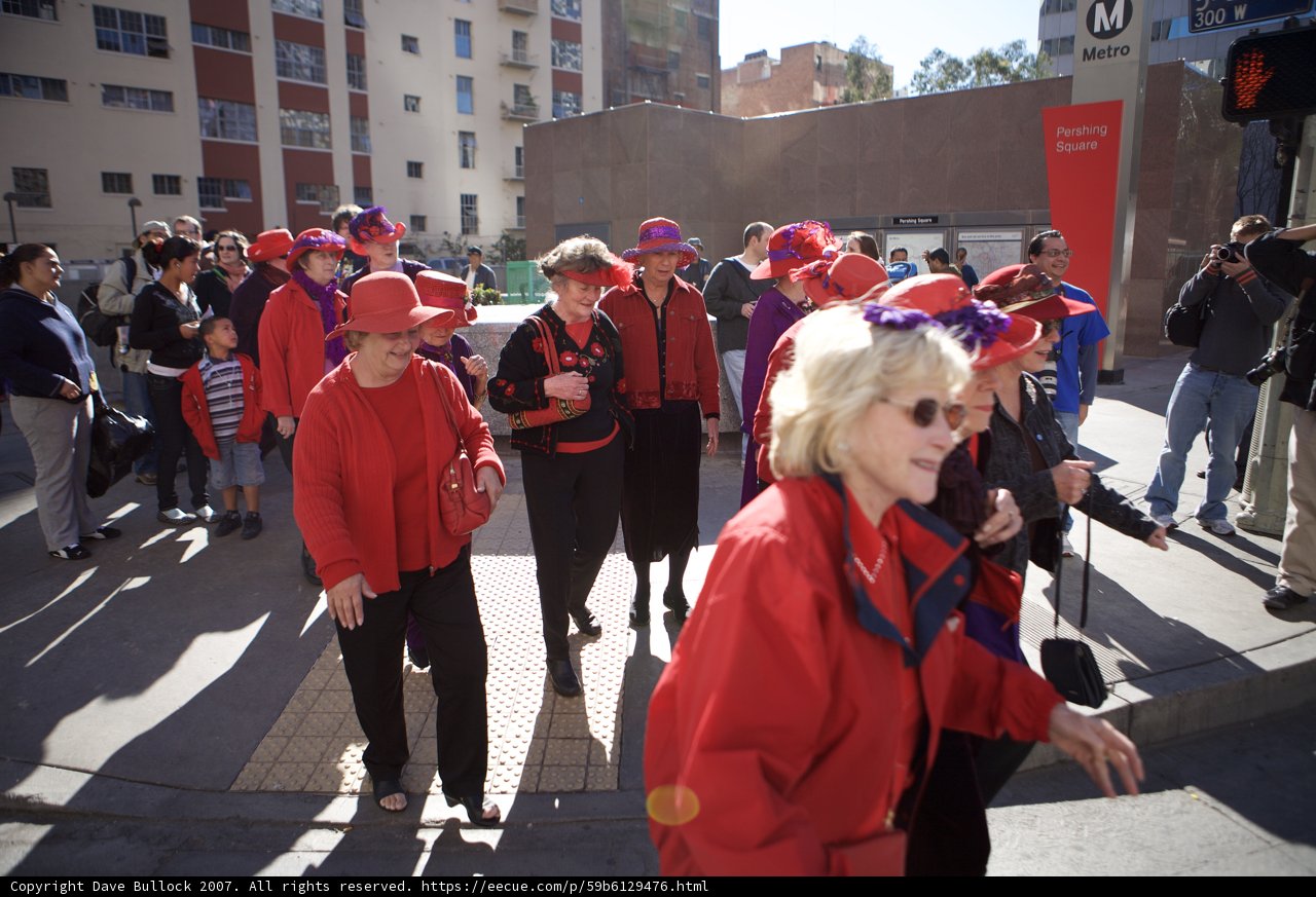 Group of Fashionable People Walking Down a Busy Downtown Street